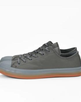 A pair of grey Moonstar low-top canvas sneakers with a grey-to-orange gradient sole