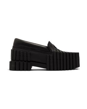 A black MSCHF 2x4 Loafer: a leather loafer upper on a chunky sole moulded from stacked 2x4 timber shapes