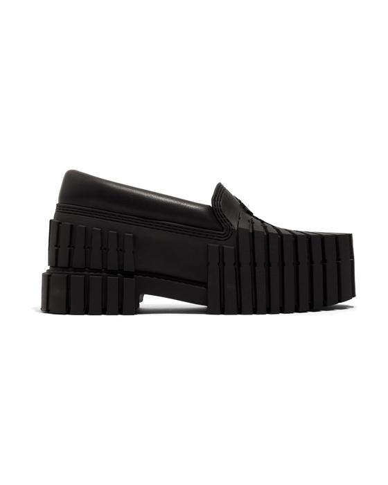 A black MSCHF 2x4 Loafer: a leather loafer upper on a chunky sole moulded from stacked 2x4 timber shapes