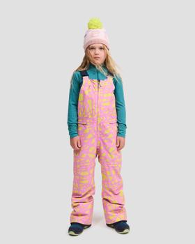 A girl wearing a pink and yellow printed namuk snow bib with a teal base layer and pink pom-pom beanie