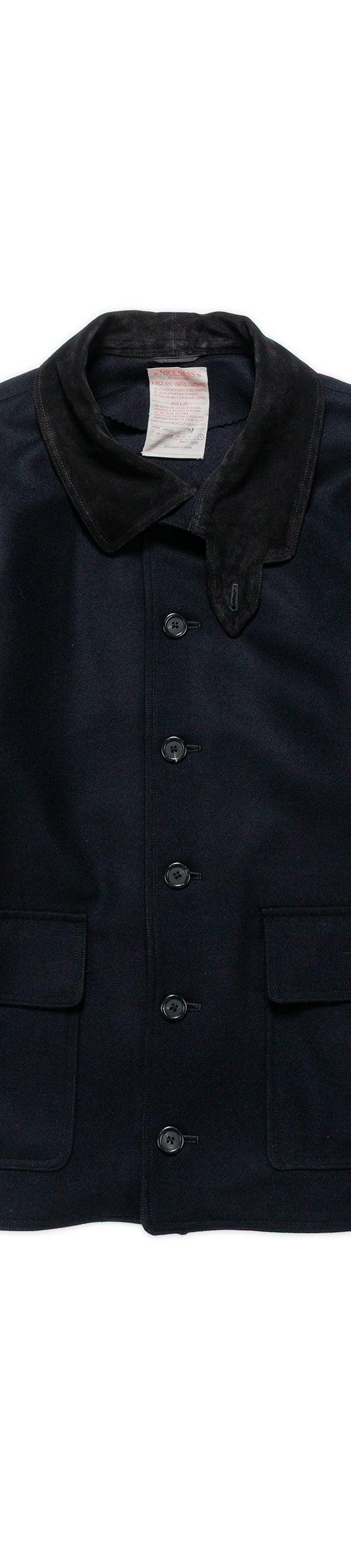 A navy wool NICENESS chore jacket with a corduroy collar on a plain background