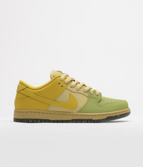 A yellow and green Nike SB Dunk Low skate shoe