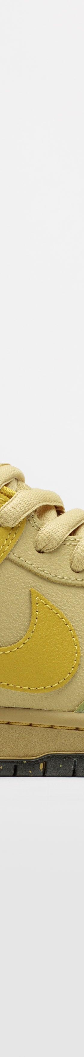 A yellow and green Nike SB Dunk Low skate shoe
