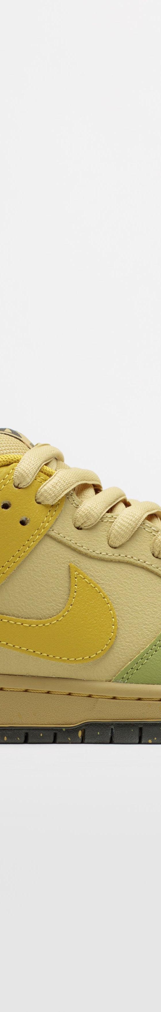 A yellow and green Nike SB Dunk Low skate shoe