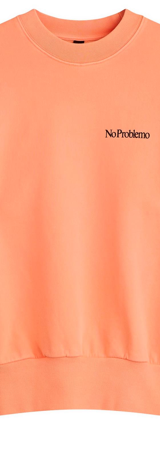 A peach No Problemo crewneck sweatshirt on a plain background