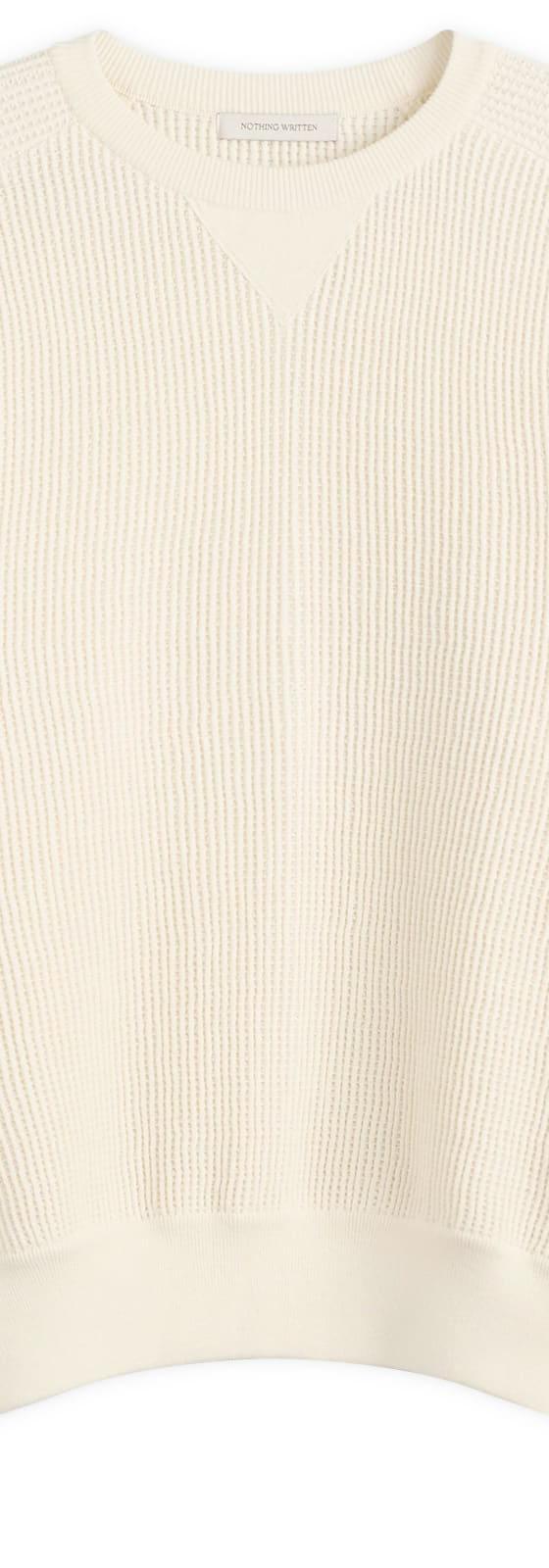 A cream waffle-knit crewneck sweater by Nothing Written