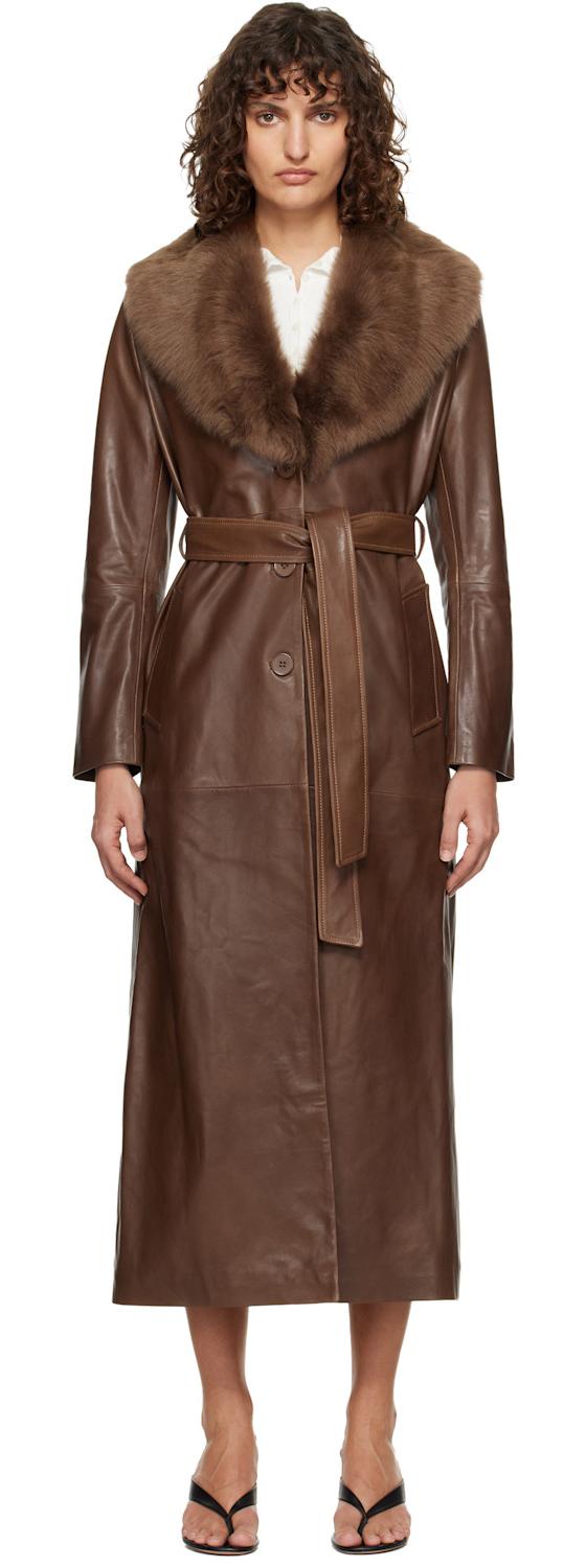 A woman wearing a brown Nour Hammour leather coat with a shearling collar