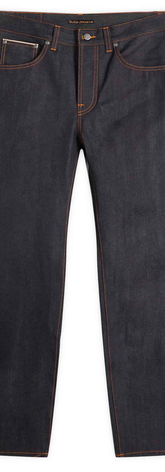 A pair of Nudie Jeans Co dry indigo selvage jeans with contrast orange stitching