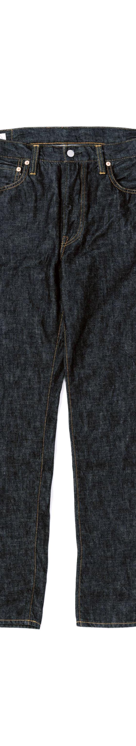 A pair of raw indigo selvedge Omoto Denim jeans on a white background