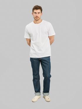 A man wearing ONI Denim raw selvedge jeans with cuffed hems and a white T-shirt