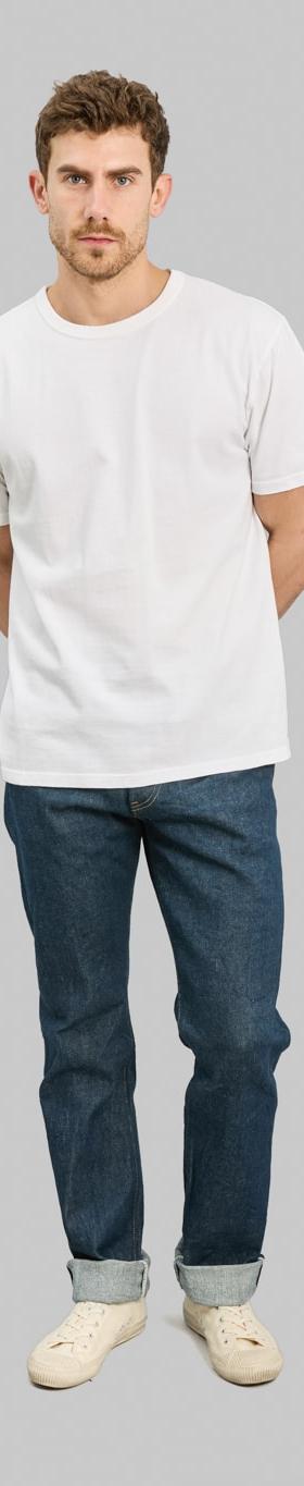 A man wearing ONI Denim raw selvedge jeans with cuffed hems and a white T-shirt