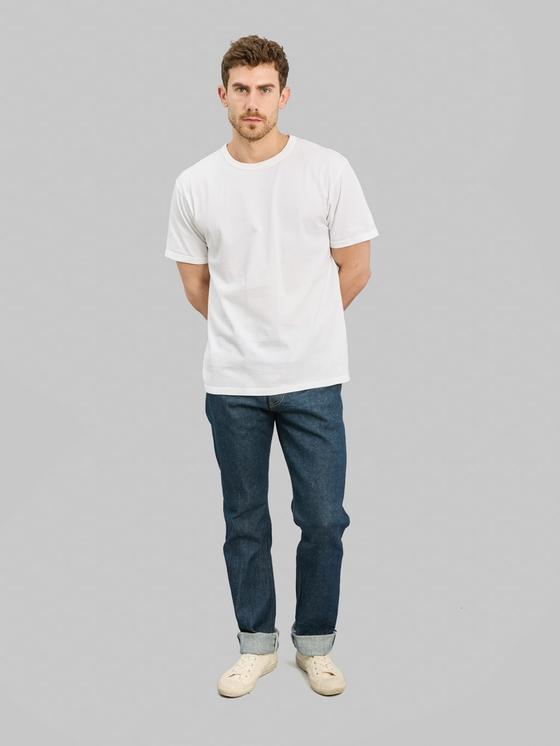 A man wearing ONI Denim raw selvedge jeans with cuffed hems and a white T-shirt