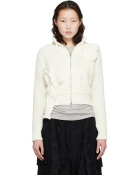 A woman wearing an off-white OPEN YY rosette-appliqué zip-up knit cardigan with a black skirt