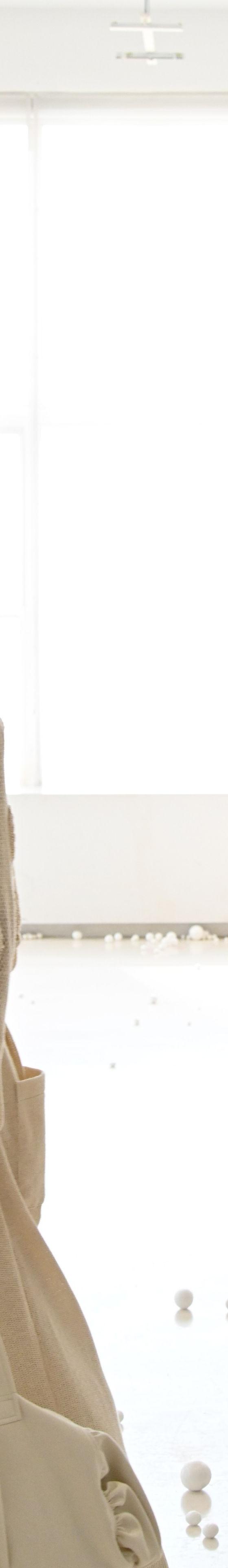Models walking in a bright studio wearing textured knitwear, oversized trousers and sneakers