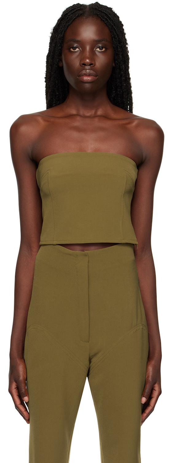 A woman wearing an olive green Paris Georgia strapless tube top with matching high-waisted trousers
