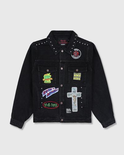 A black studded denim jacket with punk patches from PLEASURES