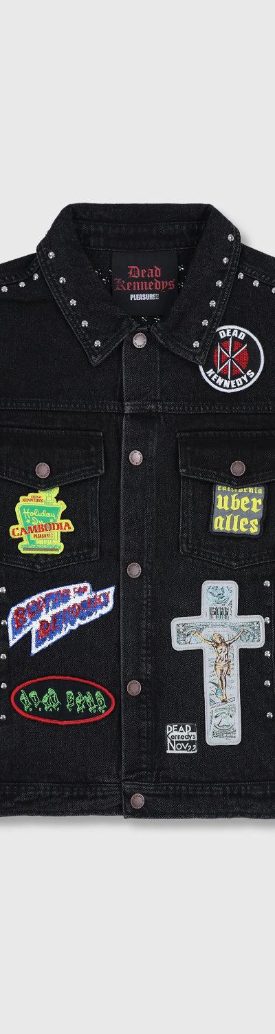 A black studded denim jacket with punk patches from PLEASURES