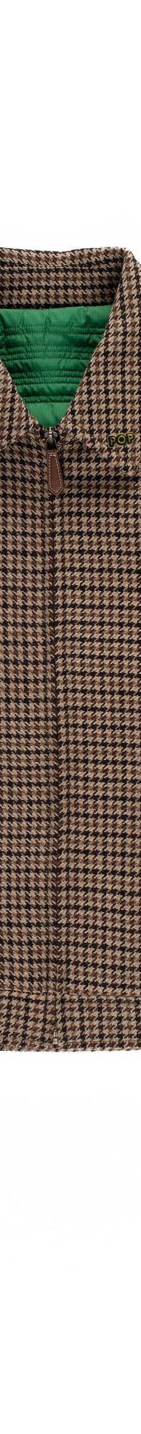 A brown houndstooth Pop Trading Company zip-up jacket on a plain white background