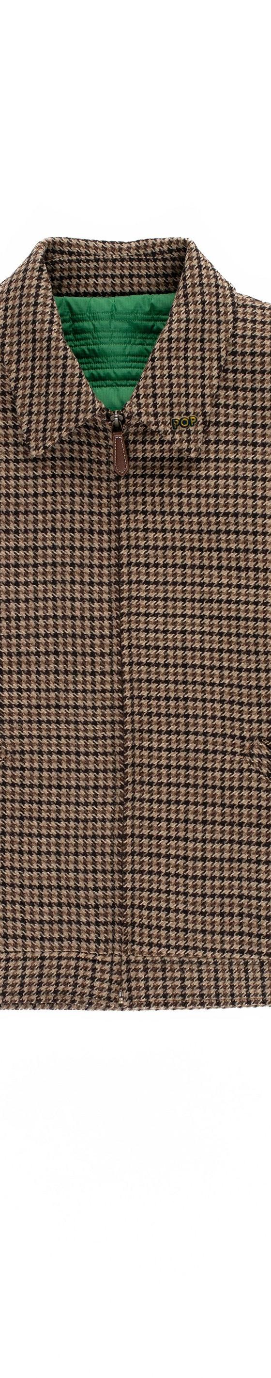 A brown houndstooth Pop Trading Company zip-up jacket on a plain white background