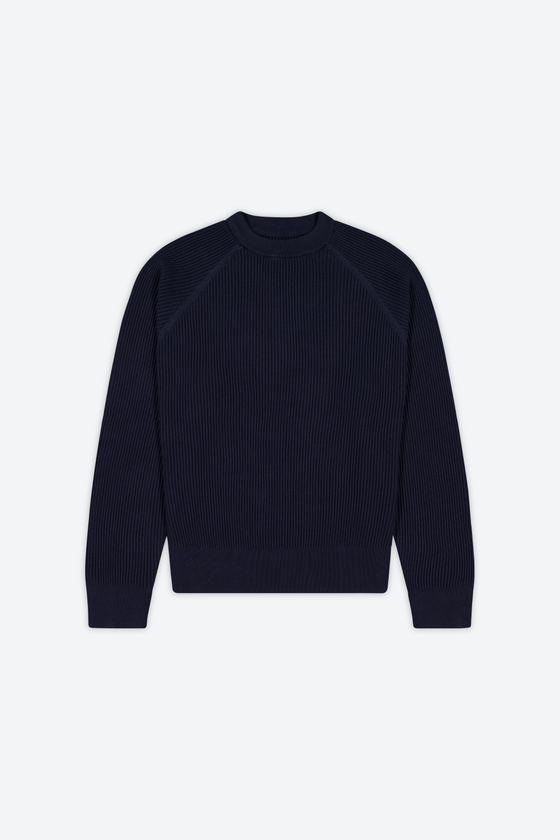 A navy ribbed raglan crewneck knit sweater on a plain background