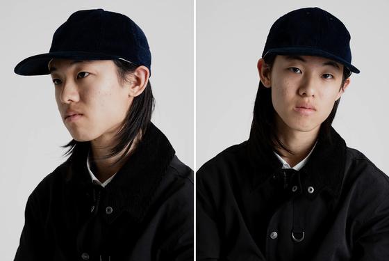 A man wearing a navy corduroy Poten ballcap with a black jacket