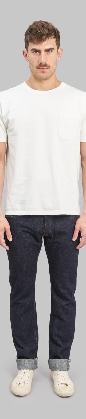 A man wearing a white pocket T-shirt with cuffed indigo Pure Blue Japan selvedge jeans
