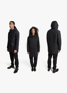 Three models wearing black QWSTION hooded parkas and black trousers