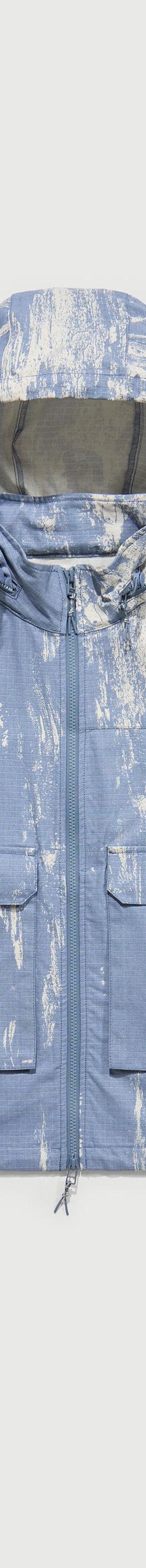 A light blue printed RCOS hooded technical shell jacket with utility chest pockets