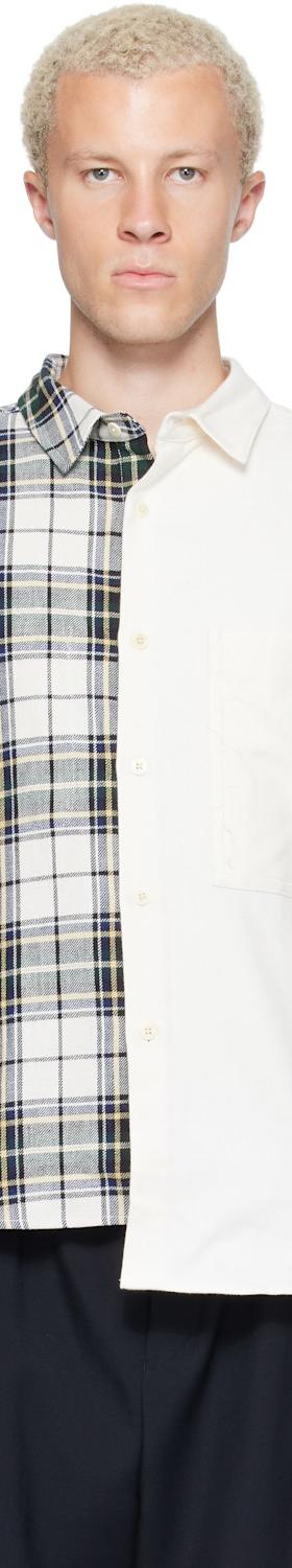 A man wearing a half-plaid, half-ivory spliced RE;CODE shirt with black trousers