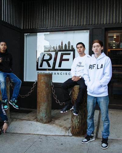 A group of young men wearing RIF LA hoodies and tees outside the storefront