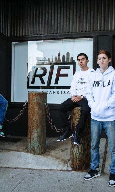A group of young men wearing RIF LA hoodies and tees outside the storefront