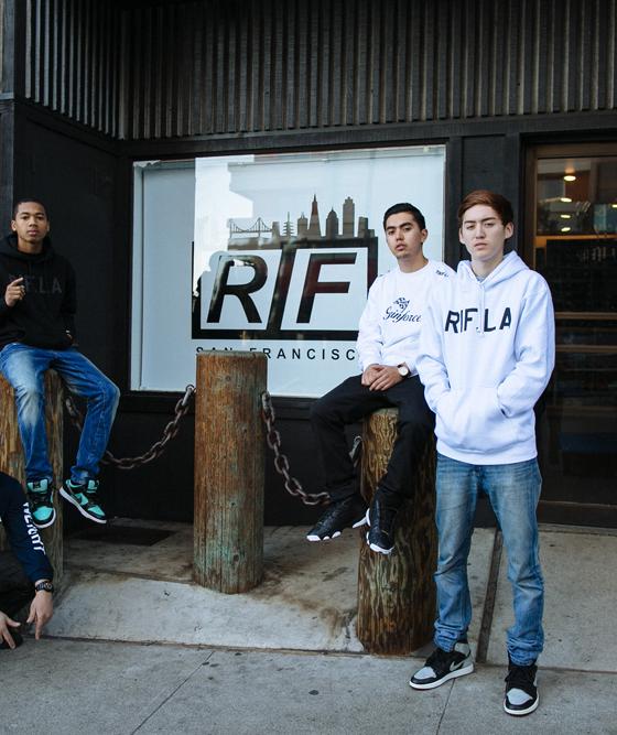 A group of young men wearing RIF LA hoodies and tees outside the storefront