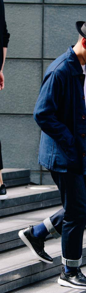 Two men walking down city steps in navy workwear and dark leather sneakers