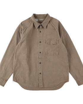A tan naturally dyed SEUVAS canvas work shirt on a plain background