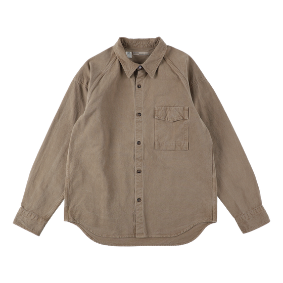 A tan naturally dyed SEUVAS canvas work shirt on a plain background