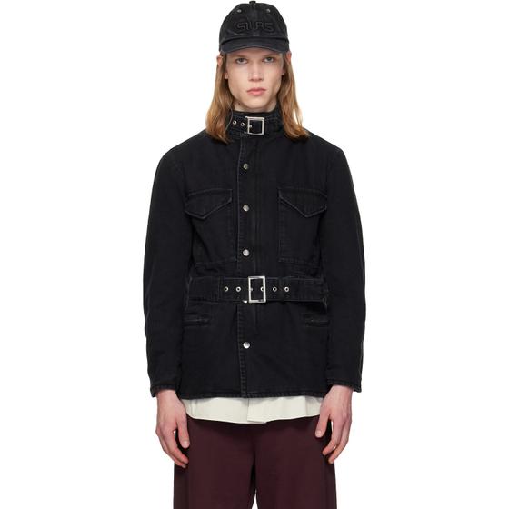 A man wearing a black belted denim jacket and cap by Silas
