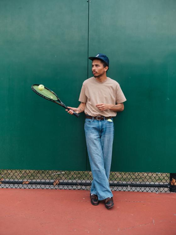 A man wearing a tan Soft Goods heavyweight t-shirt