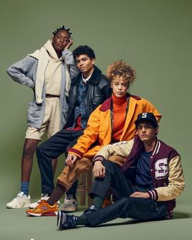 Four models in Stadium Goods varsity jackets, hoodies and sneakers against a green backdrop