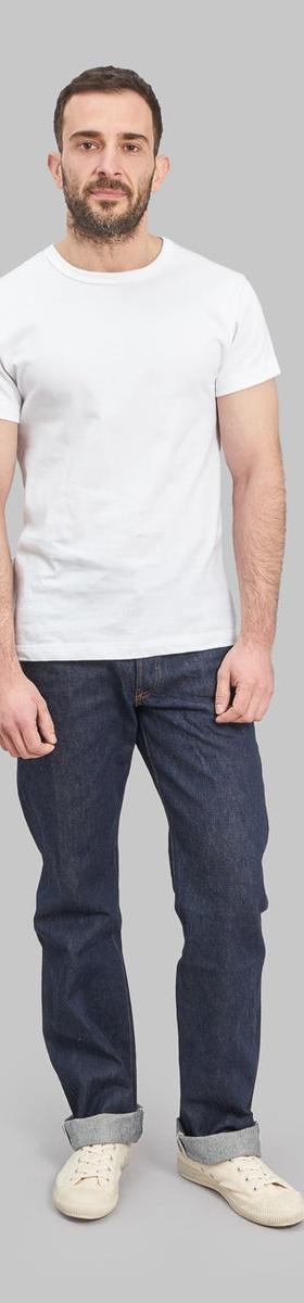A man wearing Studio D'Artisan raw selvedge denim jeans with a white T-shirt