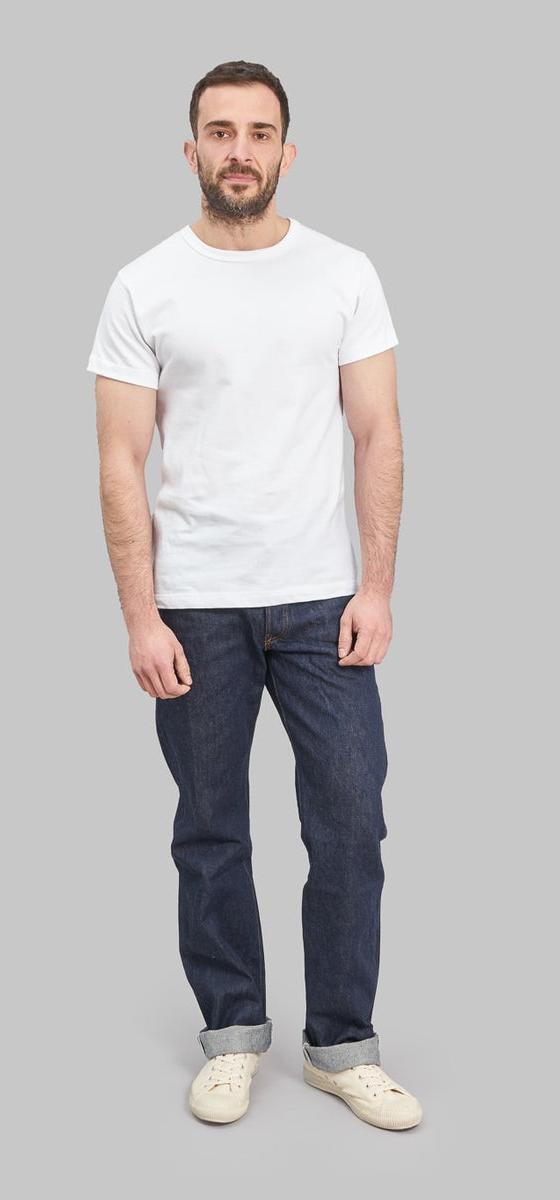 A man wearing Studio D'Artisan raw selvedge denim jeans with a white T-shirt