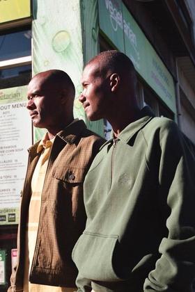 Two men wearing Stüssy jackets on a Toronto Chinatown street