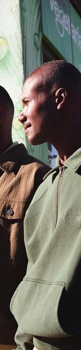 Two men wearing Stüssy jackets on a Toronto Chinatown street