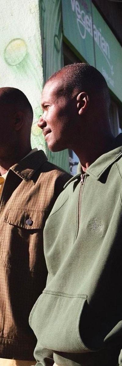 Two men wearing Stüssy jackets on a Toronto Chinatown street