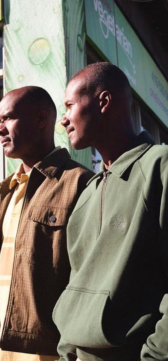 Two men wearing Stüssy jackets on a Toronto Chinatown street