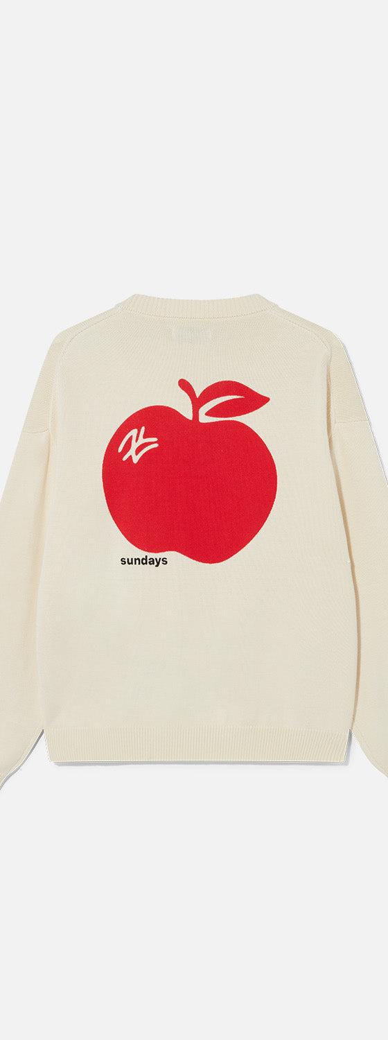 A cream Sundays knitted sweater with a red apple motif on the back