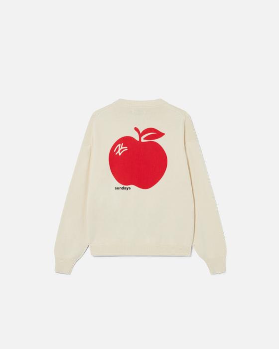 A cream Sundays knitted sweater with a red apple motif on the back