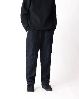 A man wearing navy TEATORA Wallet Pants with a black knit sweater