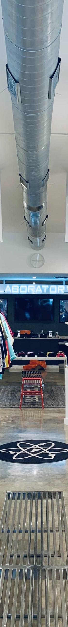 The interior of The Laboratory DTX sneaker shop, with sneakers and apparel displayed along bright white walls