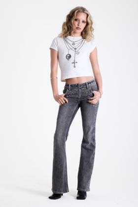 A woman wearing studded grey flared The Ragged Priest jeans with a white baby tee and layered cross chains