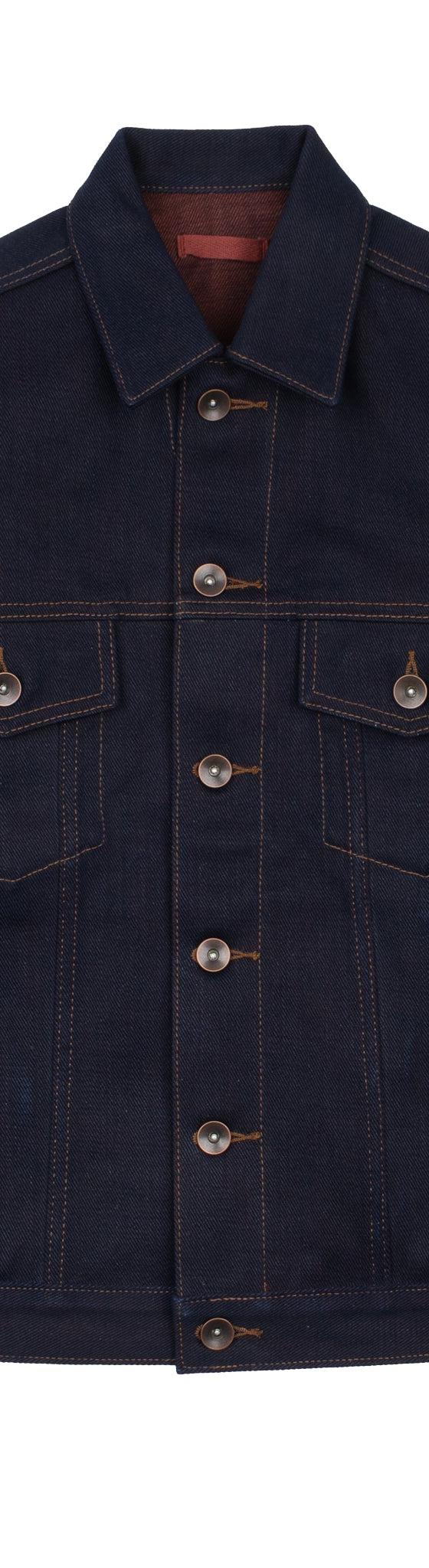 A raw indigo selvedge denim trucker jacket on a plain white background
